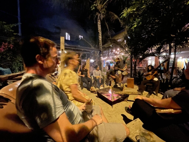 Coco Loco guests enjoying a fire and playing music